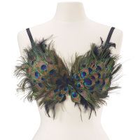 a white mannequin wearing a bra with peacock feathers on it's chest