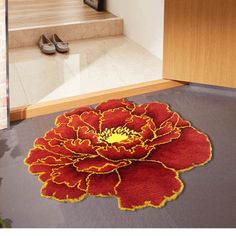 a red and yellow flower rug on the floor