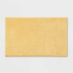 a yellow rug on a white background