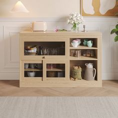 a wooden cabinet with glass doors and shelves filled with cups, vases and other items