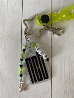 a keychain with an american flag and starfish charms attached to it on a white wooden surface