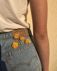 a person with yellow flowers in their back pocket