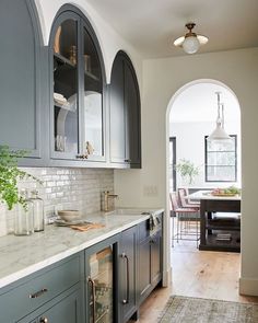 an instagram page with grey cabinets and white marble countertops in the kitchen area