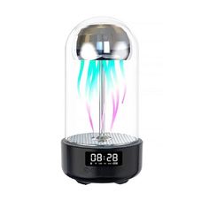 an alarm clock sitting on top of a glass dome with colorful lights in the middle