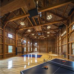 an indoor basketball court with wood paneling and ceiling lighting is seen in this image