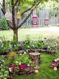 an outdoor garden with lots of plants and flowers in the center, surrounded by wooden stumps