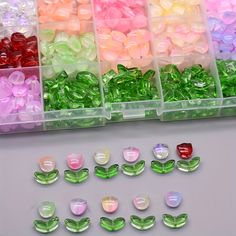 several different colors of beads in plastic containers