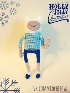 a crocheted stuffed animal is posed in front of a snowflake background