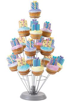 a bunch of cupcakes that are sitting on a stand in the shape of a tower