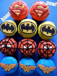 some cupcakes that are decorated like batman and superman logos