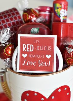 a valentine's day gift basket with candy, candies and card saying it's red - iguaous how much love you