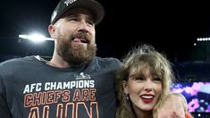 a man and woman standing next to each other in front of a crowd at a sporting event