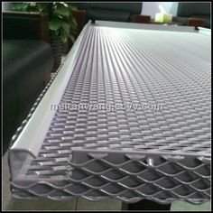 an aluminum sheet is shown on the floor in front of a couch and table with chairs