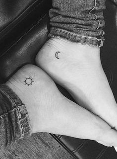 two small sun and moon tattoos on the feet