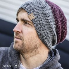 a man wearing a knitted beanie looks off into the distance with his eyes closed