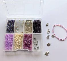 the beads and bracelets are arranged in a plastic container with beading supplies nearby