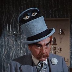 a man wearing a top hat with two eyes