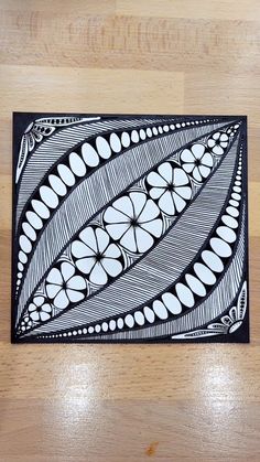 a black and white drawing on top of a wooden table