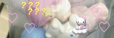 a bunch of stuffed animals sitting inside of a plastic bag with question marks on it