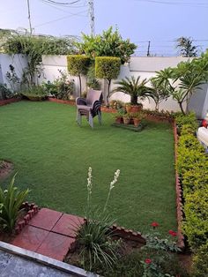 a small backyard with lawn and seating area