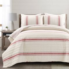 a bed with red and white striped comforter