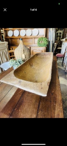 a large wooden bowl sitting on top of a table