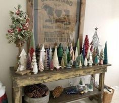there are many small christmas trees on the shelf in front of the sign that says deer brand