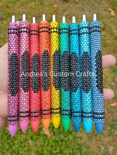 six different colored pens with black dots on them