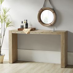 a wooden table sitting next to a potted plant