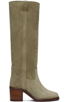 a women's boot with wooden heel and side zippers on the bottom, beige sued