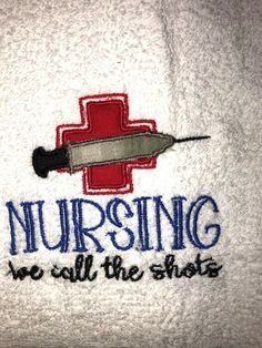 a white towel with the words nursing we call the shots on it and a red cross