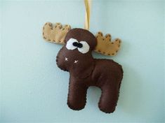 a stuffed moose ornament hanging on a wall