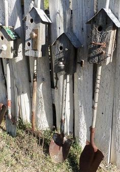 a wooden fence with bird houses on it