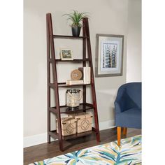 a leaning shelf with some items on it in a room next to a blue chair