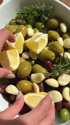 olives and lemons are mixed together in a bowl