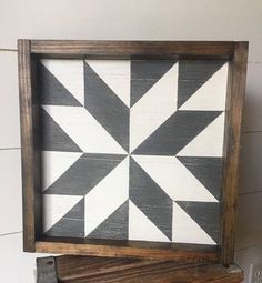 a wooden frame with a black and white pattern on it