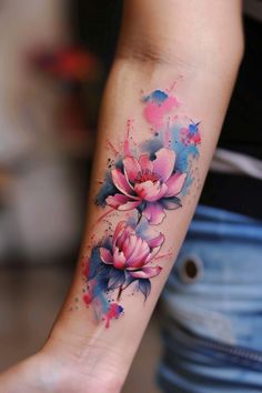 a woman's arm with watercolor flowers on it
