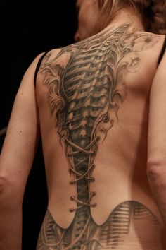 the back of a man with tattoos on his body