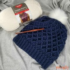 a crocheted hat with a ball of yarn next to it