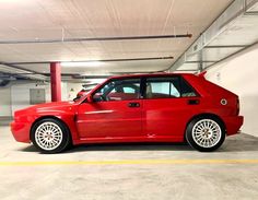 a red car parked in a parking garage