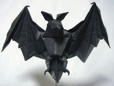 an origami bat hanging from the ceiling