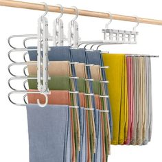 a rack with towels hanging from it's sides and clothes hanging on the hangers