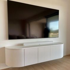 a flat screen tv mounted to the side of a wall