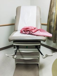 a hospital bed with a pink blanket on it