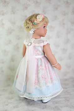 a doll with blonde hair wearing a dress