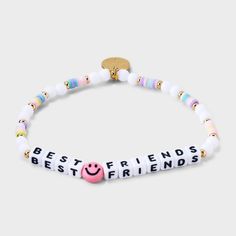 a bracelet with the words best friends on it and a smiley face beaded in white beads