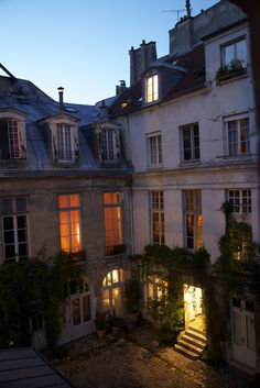 an apartment building with many windows lit up at night