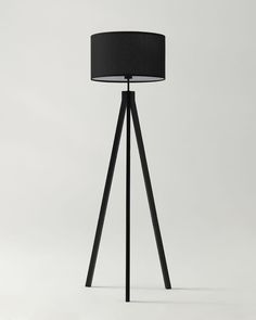 a floor lamp with a black shade on it