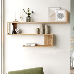 two wooden shelves on the wall above a green chair