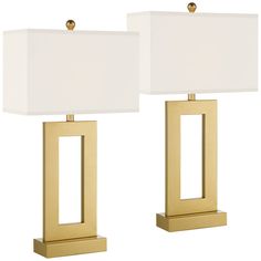 pair of modern brass table lamps with white linen shades on each lamp and gold base